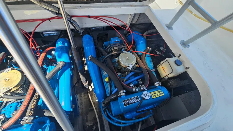 Engine compartment of a 1992 Luhrs Tournament 300 boat, featuring blue engine components.