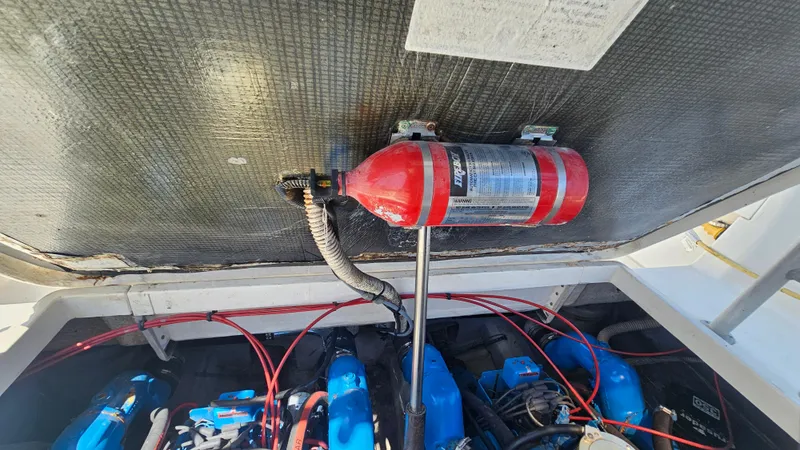 Engine compartment of a 1992 Luhrs Tournament 300 with fire extinguisher and wiring visible.