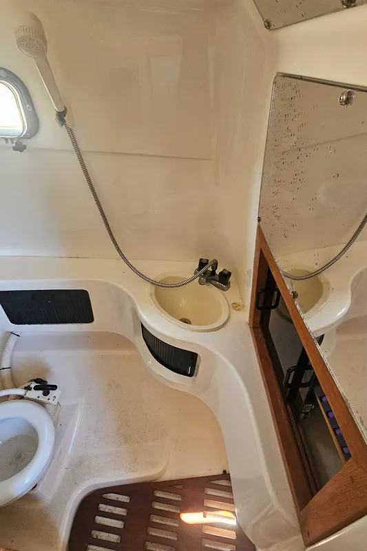 1992 Luhrs Tournament 300 boat bathroom with shower, sink, and mirror.