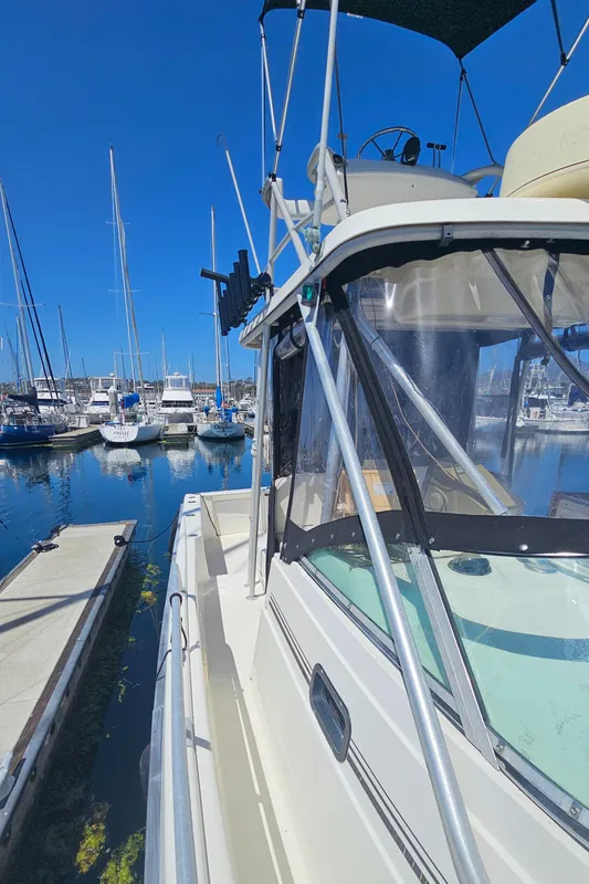 1992 Luhrs Tournament 300 boat docked at marina under clear blue sky.