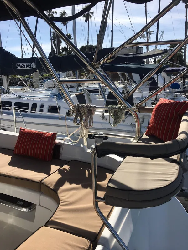 2006 Hunter 41 Deck Salon yacht interior with cushioned seating and marina view.