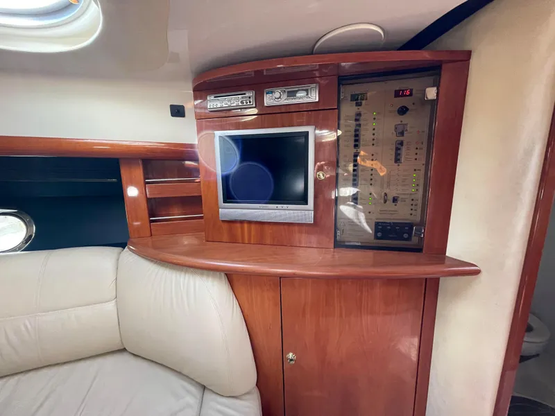 Interior of 2004 Cranchi Endurance 41 yacht with wood paneling and entertainment system.