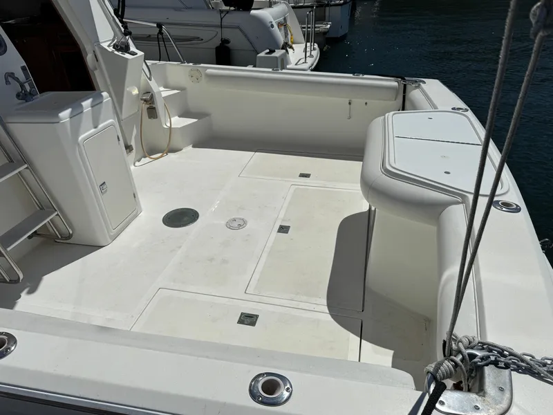 2003 Mediterranean 38 Convertible boat deck with seating and storage compartments.
