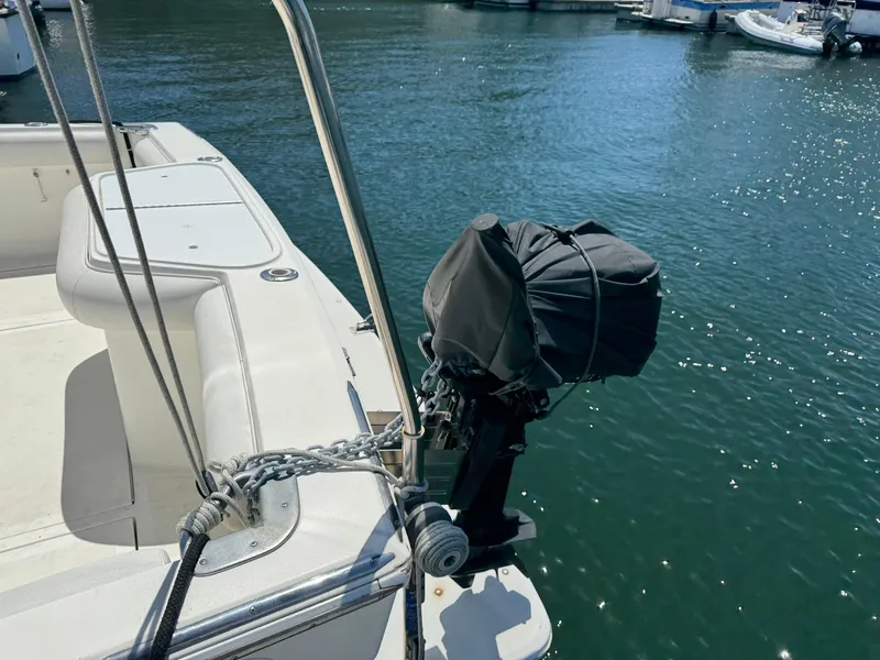 2003 Mediterranean 38 Convertible boat with covered outboard motor at marina.