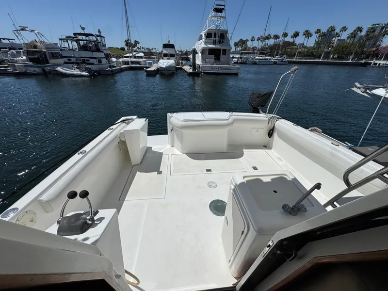 2003 Mediterranean 38 Convertible yacht docked in a marina, featuring a spacious deck area.