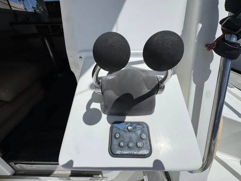 Control panel of a 2003 Mediterranean 38 Convertible boat with dual throttle levers.