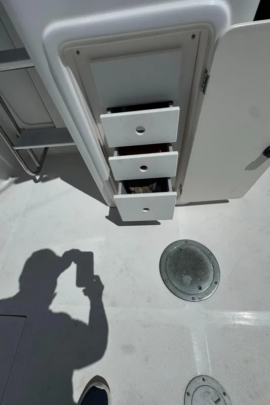 2003 Mediterranean 38 Convertible boat interior with open storage drawers.