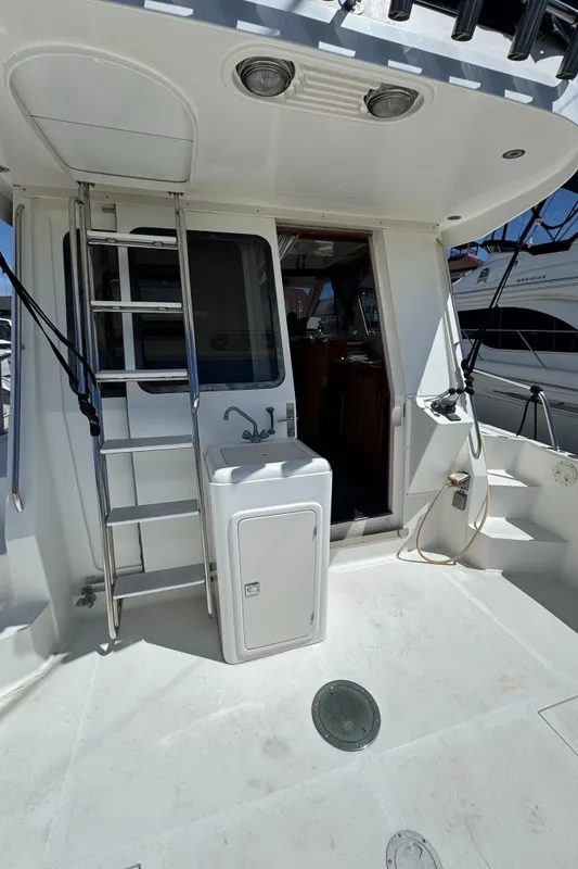 2003 Mediterranean 38 Convertible yacht deck with ladder and door.
