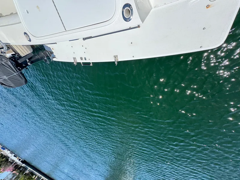 Aerial view of a 2003 Mediterranean 38 Convertible yacht on clear water.