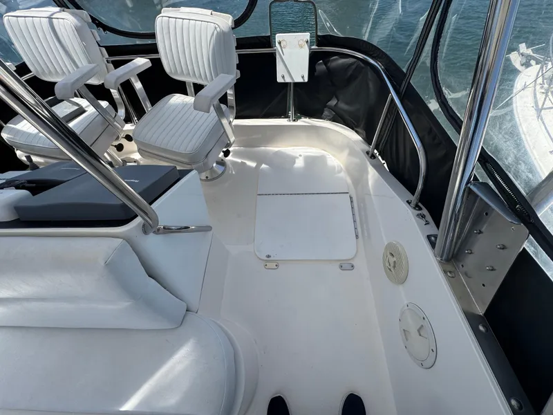 2003 Mediterranean 38 Convertible boat interior with white seating and sleek design.