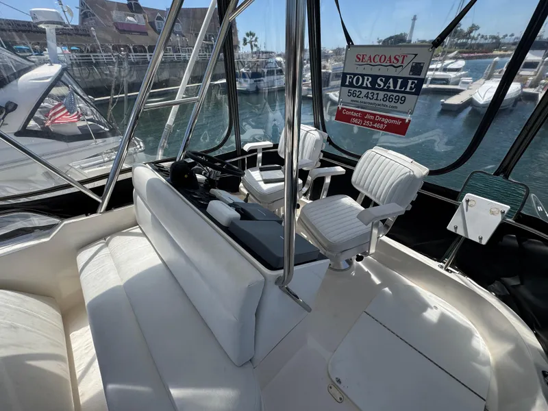 2003 Mediterranean 38 Convertible yacht interior with seating, for sale sign visible.