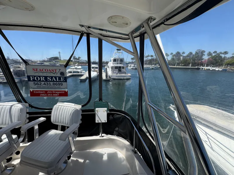 2003 Mediterranean 38 Convertible yacht for sale, docked in marina, interior view.