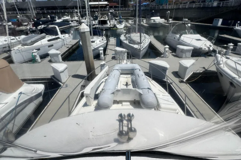 2003 Mediterranean 38 Convertible yacht docked at a marina with other boats.