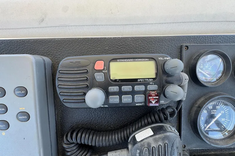 Marine radio and gauges on a 2003 Mediterranean 38 Convertible boat dashboard.