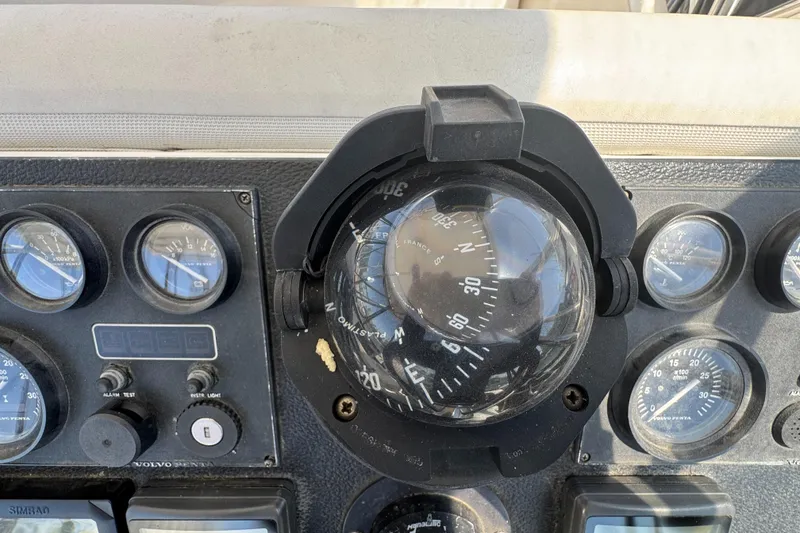 Compass and gauges on 2003 Mediterranean 38 Convertible boat dashboard.
