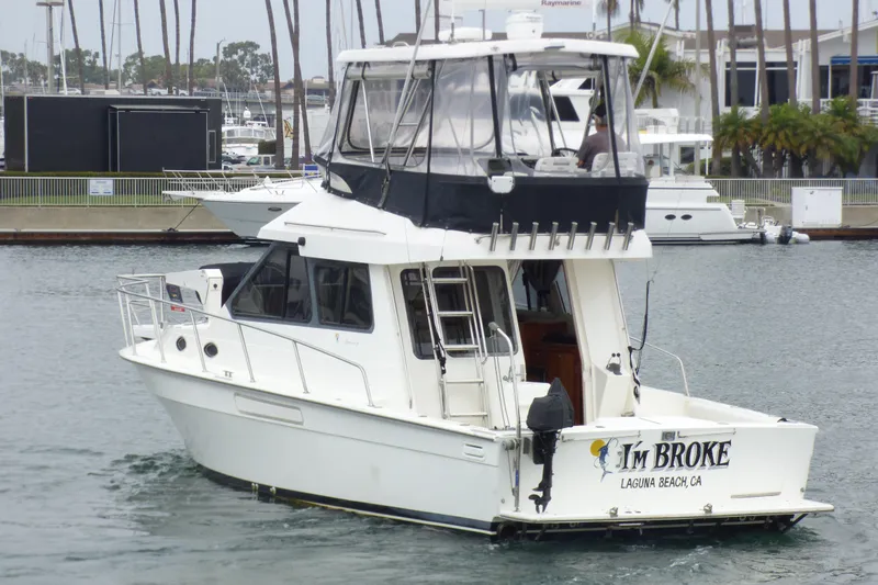 2003 Mediterranean 38 Convertible yacht in marina, named "I'm Broke," Laguna Beach, CA.