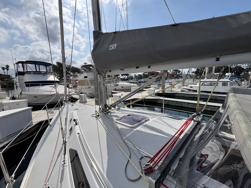 2005 Catalina 320 sailboat docked at marina, featuring deck and rigging.