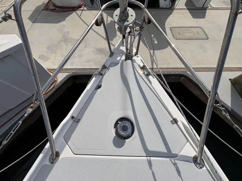 Bow of 2005 Catalina 320 sailboat with stainless steel railings at dock.