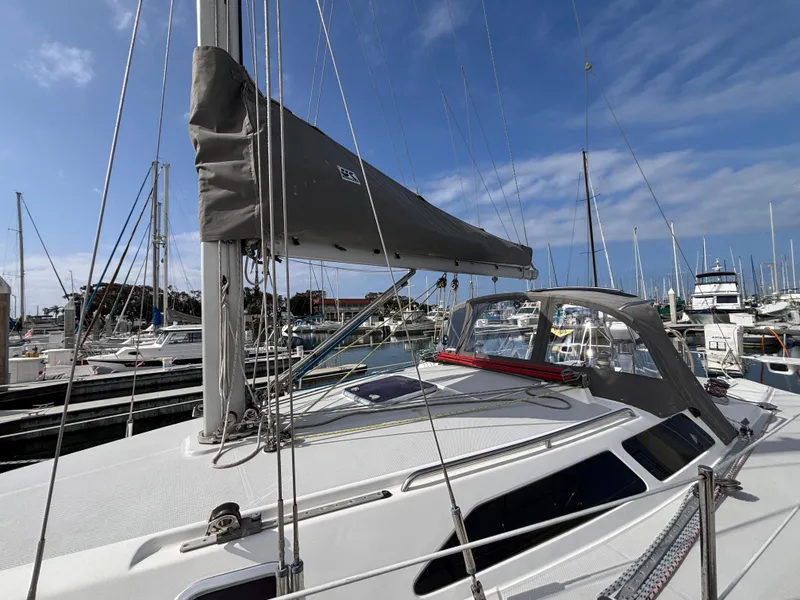 Catalina 320 sailboat from 2005 docked in a marina under a clear blue sky.