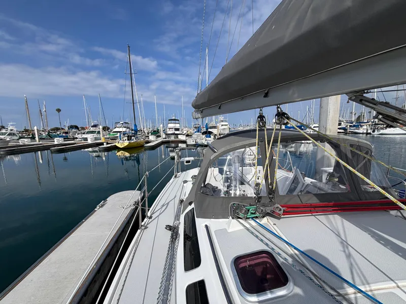 2005 Catalina 320 sailboat docked in a marina with clear skies and calm waters.