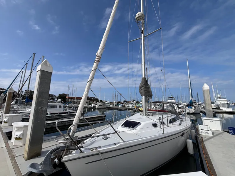 Catalina 320 sailboat docked at marina under clear blue sky, 2005 model.