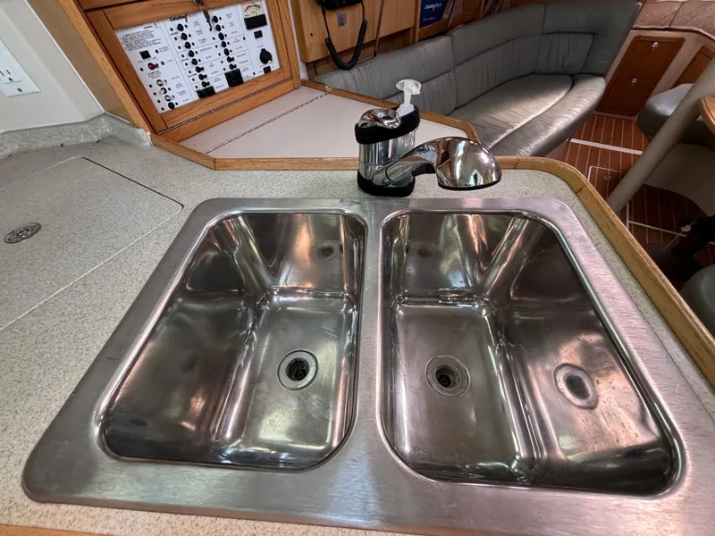 Double stainless steel sink in 2005 Catalina 320 yacht kitchen interior.