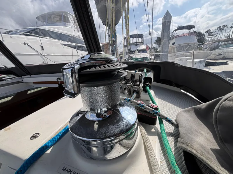 Sailboat deck with winch and ropes, Catalina 320, 2005 model, docked at marina.