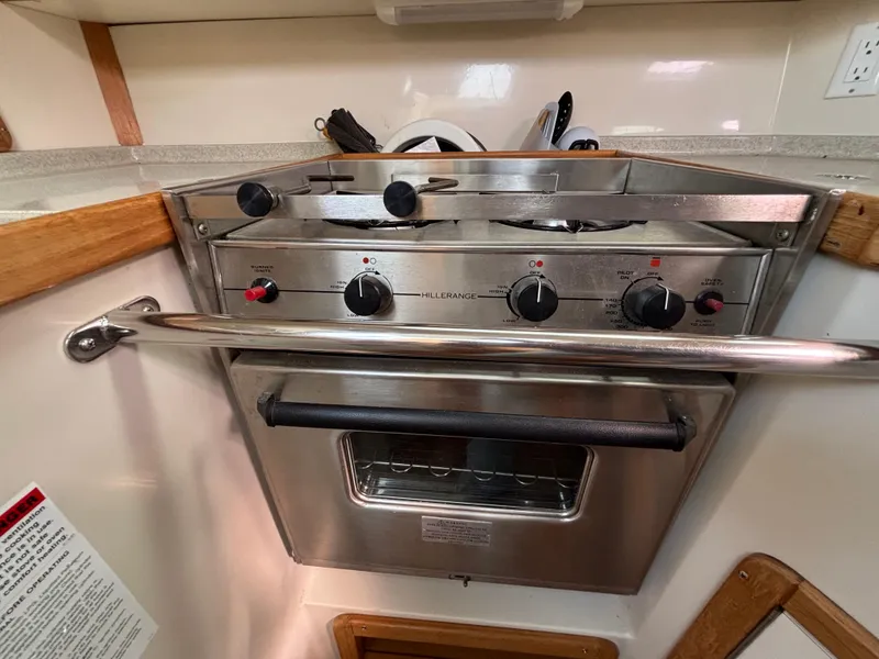 Stainless steel stove and oven in a 2005 Catalina 320 yacht kitchen.