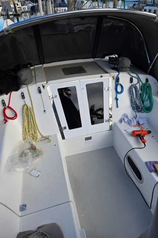 2005 Catalina 320 sailboat cockpit with ropes, storage, and equipment.