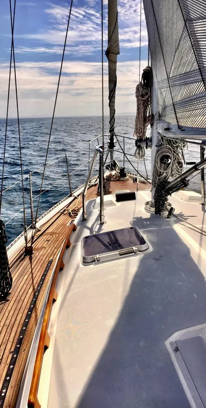Sailing on a 1987 Norseman 400 yacht, open sea view, clear skies.