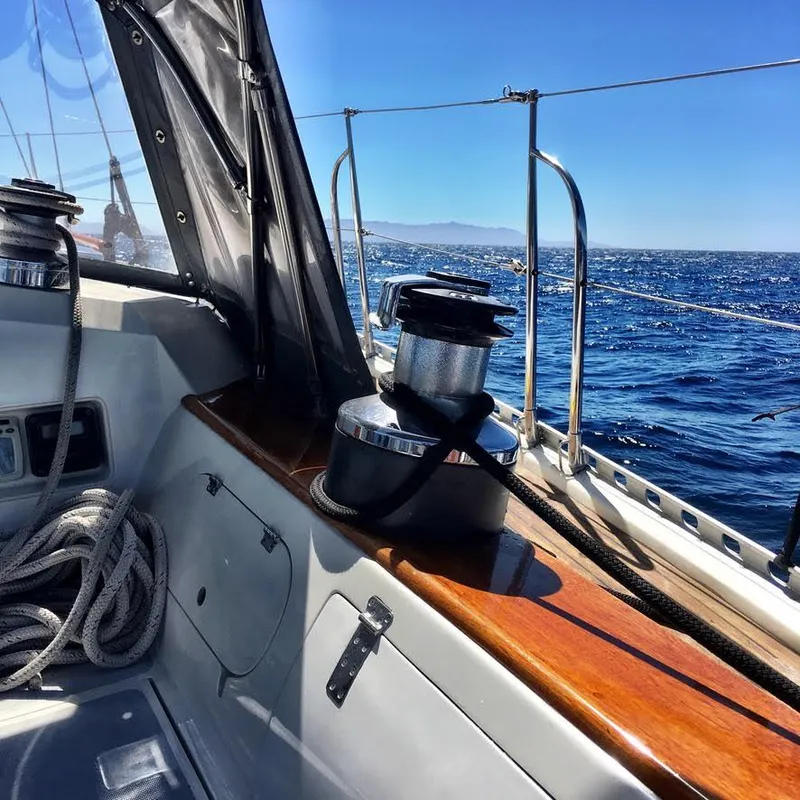 Sailing on a 1987 Norseman 400 yacht, featuring a winch and ocean view.