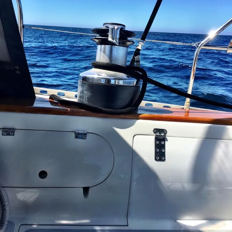 Sailboat deck view with winch, Norseman 400, 1987, ocean in background.