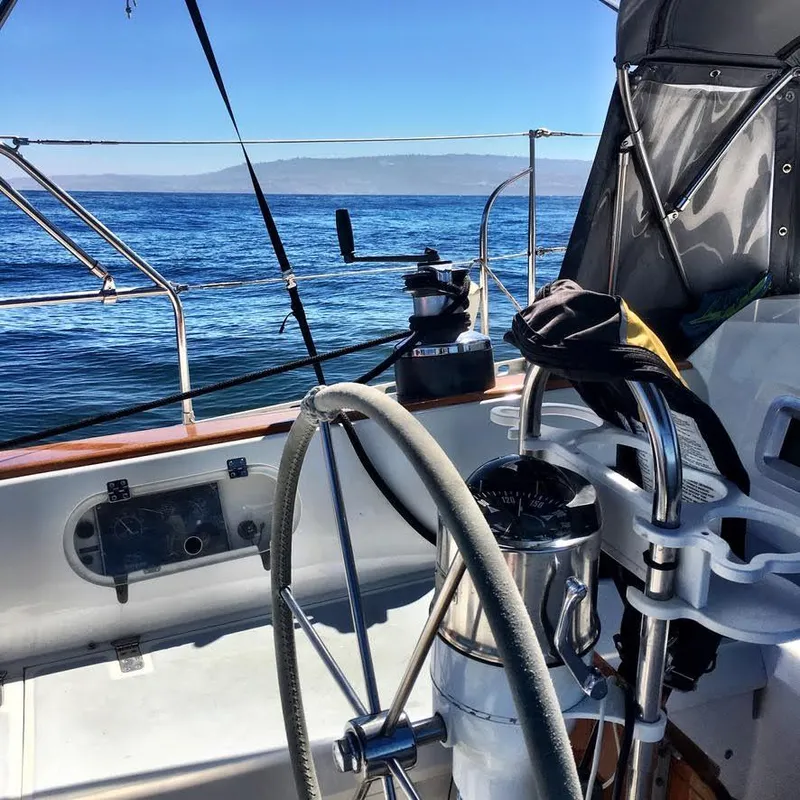 Sailboat cockpit view on a 1987 Norseman 400, steering wheel and ocean in background.
