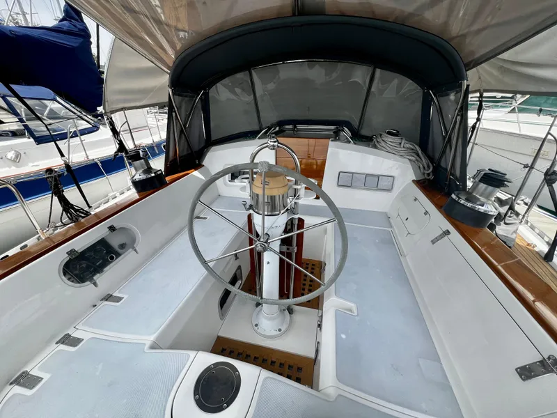 Cockpit of 1987 Norseman 400 sailboat with steering wheel and canopy.