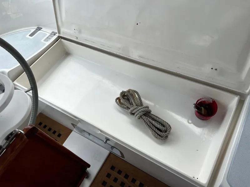 1987 Norseman 400 yacht cockpit storage with rope and red cup.