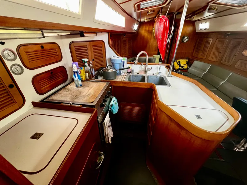 1987 Norseman 400 yacht interior with kitchen, sink, and seating area.