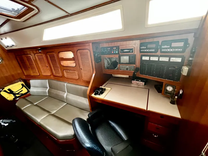 1987 Norseman 400 yacht interior with navigation station and seating area.