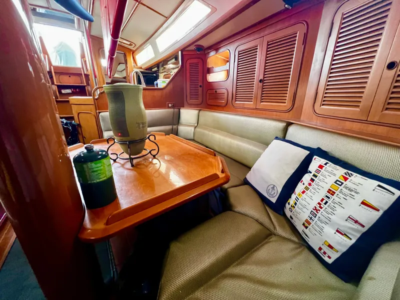 Interior of 1987 Norseman 400 yacht with wooden finishes and cozy seating area.