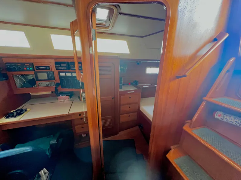 Interior of 1987 Norseman 400 sailboat with navigation station and wooden cabinetry.