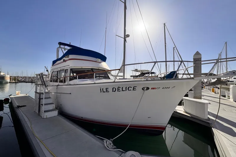 1983 Sea Ranger 45 Sun Deck yacht docked at marina under clear sky.