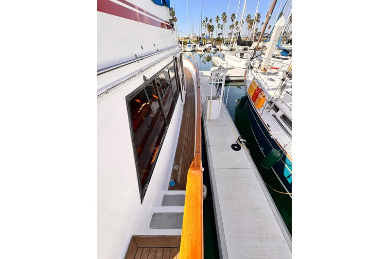 1983 Sea Ranger 45 Sun Deck yacht docked at marina with sailboats.