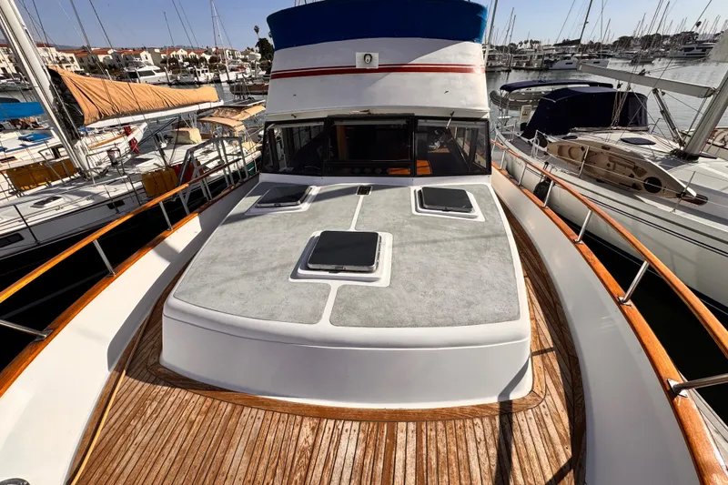 1983 Sea Ranger 45 Sun Deck yacht docked at marina, showcasing spacious deck and sleek design.