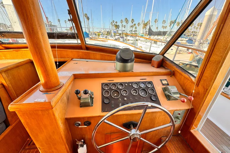 1983 Sea Ranger 45 Sun Deck helm with classic wooden dashboard and steering wheel.