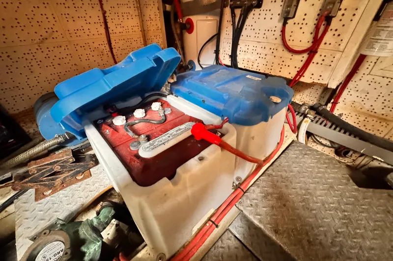 Battery compartment of 1983 Sea Ranger 45 Sun Deck with red and blue wiring.