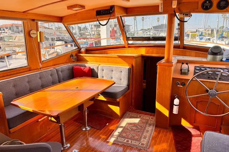 Interior of 1983 Sea Ranger 45 Sun Deck yacht with wooden furnishings and helm.