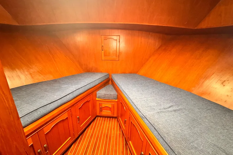 1983 Sea Ranger 45 Sun Deck cabin with wooden interior and twin beds.