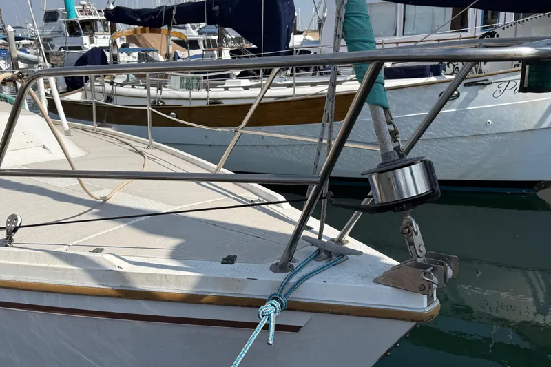 1987 Catalina 36 sailboat bow with stainless steel railing and mooring lines.
