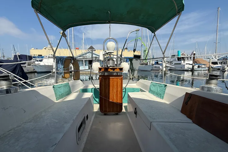 Cockpit view of 1987 Catalina 36 sailboat docked in a marina.