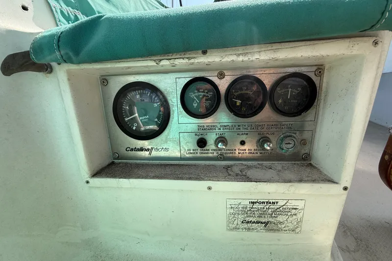 Control panel of a 1987 Catalina 36 yacht with gauges and instructions.