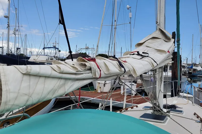 1987 Catalina 36 sailboat with furled sail in marina setting.
